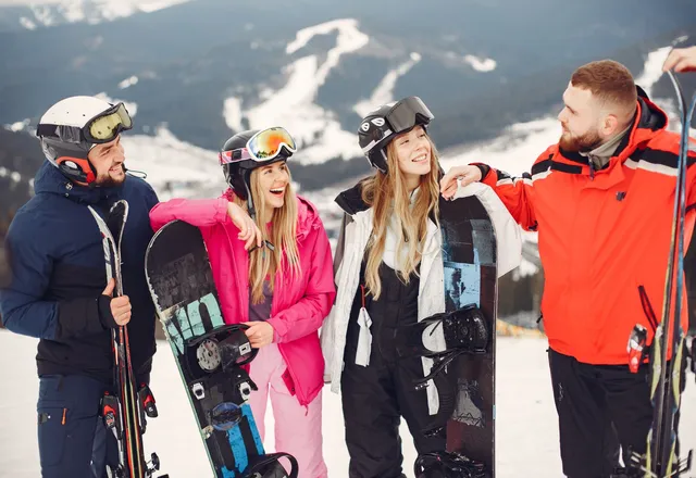 Friends laughing on a sunny ski slope