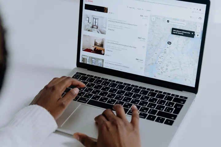 Writing and optimising an Airbnb listing on a laptop