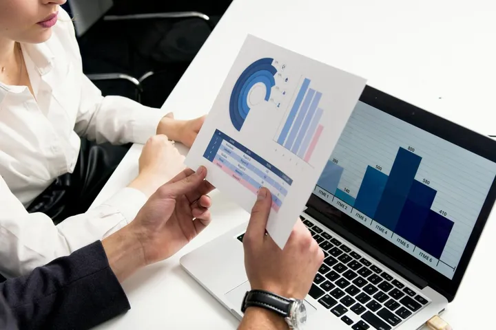 A monthly owner statement with charts on a laptop