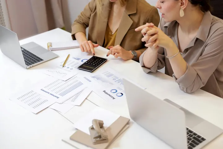 Reviewing booking and revenue reports at a desk